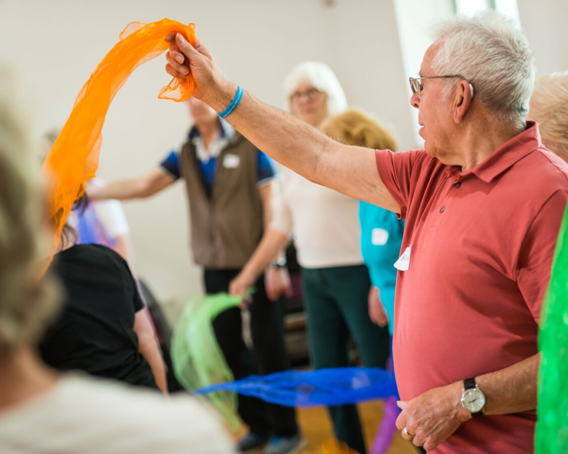 people waving ribbons in a workshop