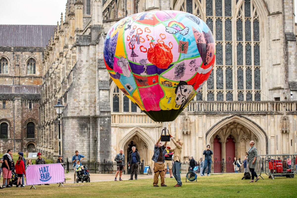 people letting go of a hot air balloon