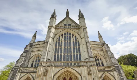 Winchester Cathedral against a backdrop of blue