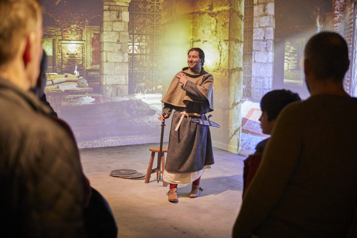 A man in Anglo Saxon attire performs for a crowd