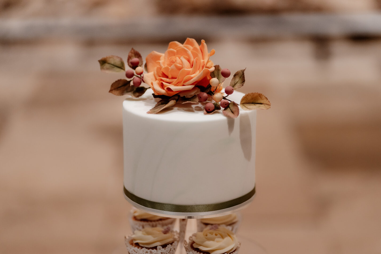 A wedding cake with autumnal flowers