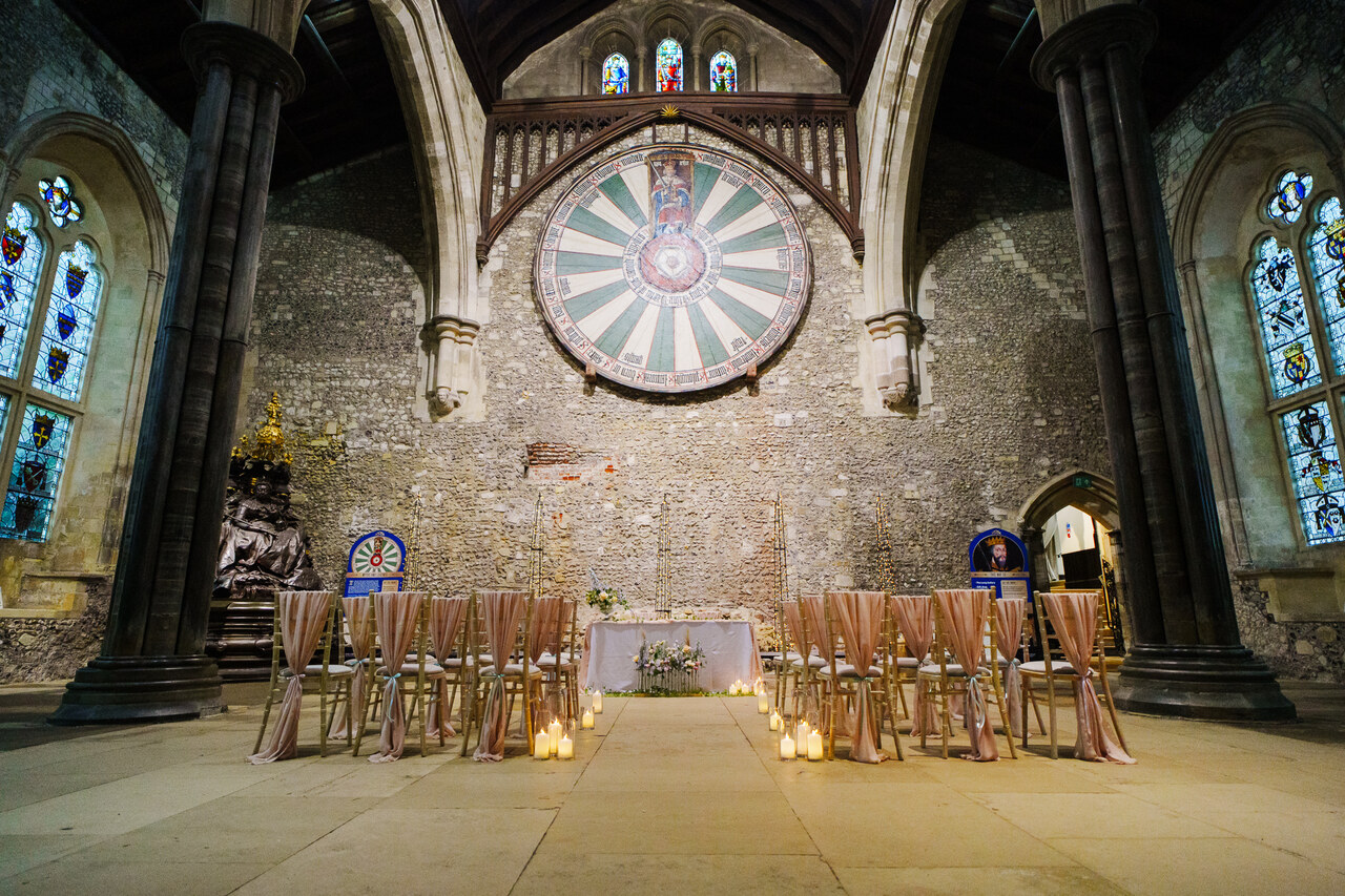 The Great Hall set up for a wedding with peach chairs