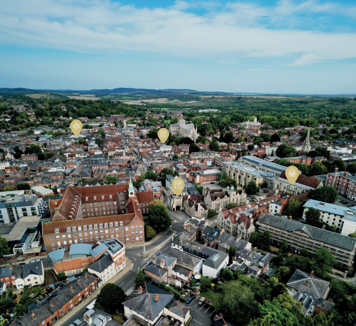 An aerial overview of Winchester with venue icons for 878 AD, City museum, The west gate and The Great Hall