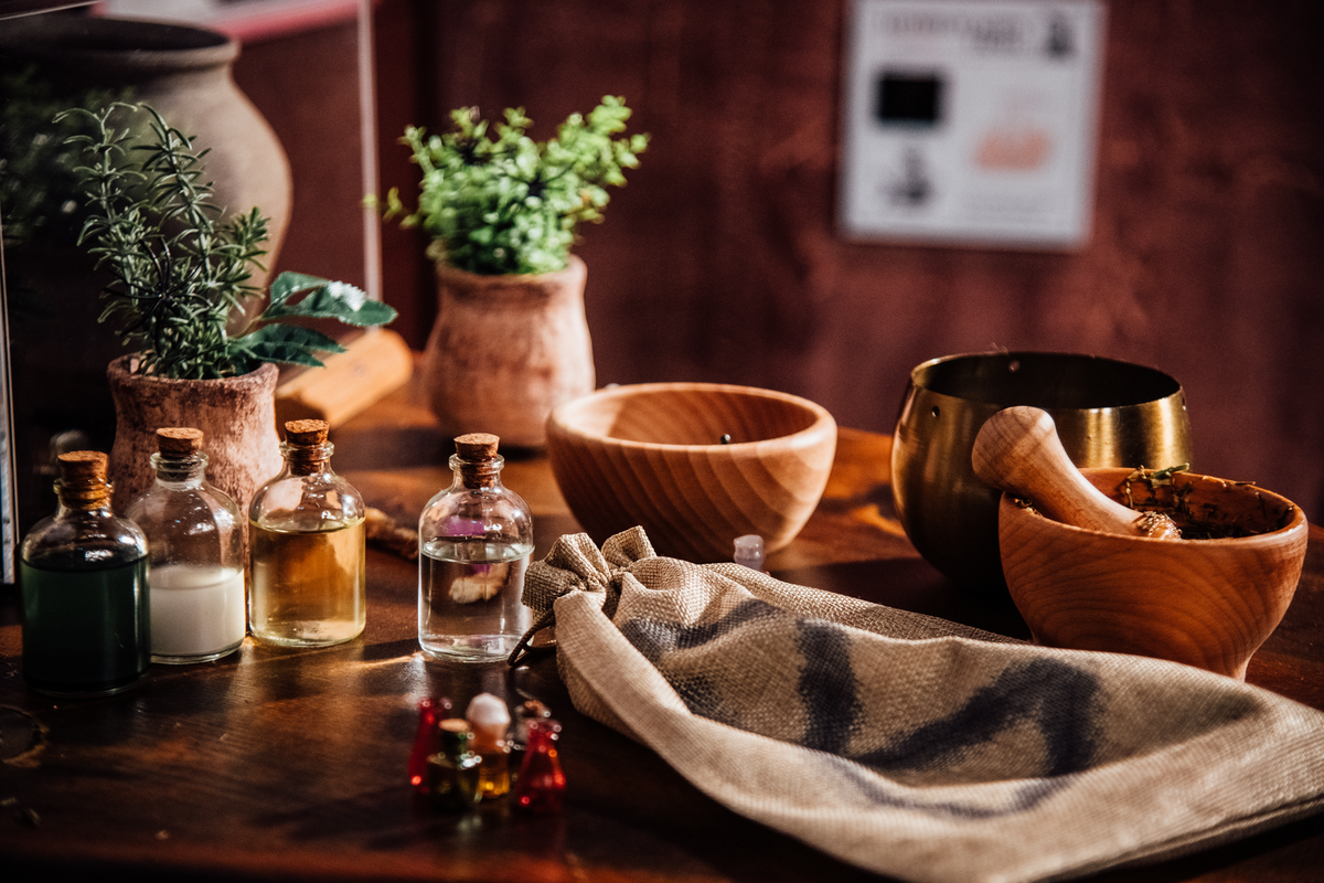 A table covered in small glass bottles and wooden bowls