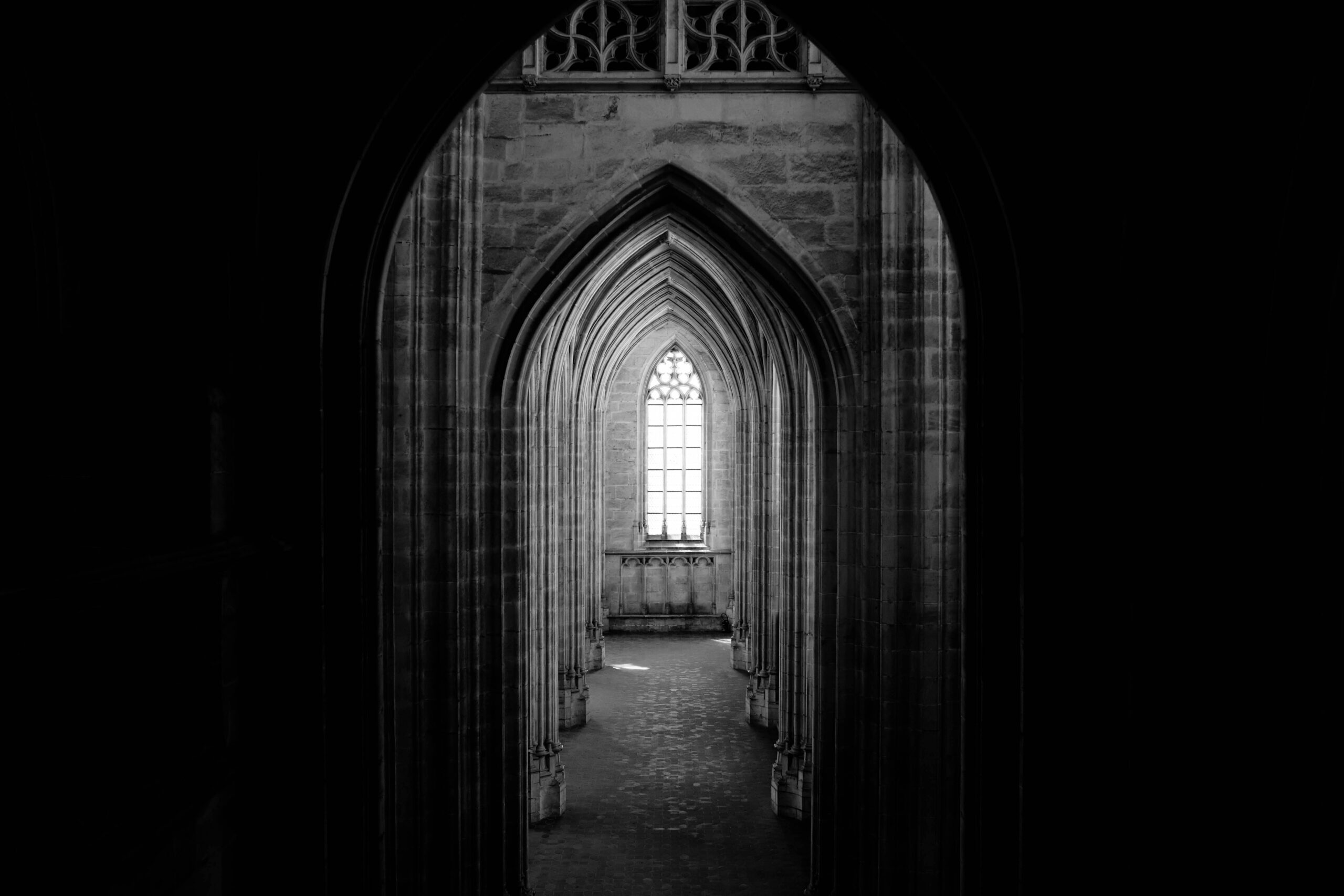 A dark corridor of Gothic archways