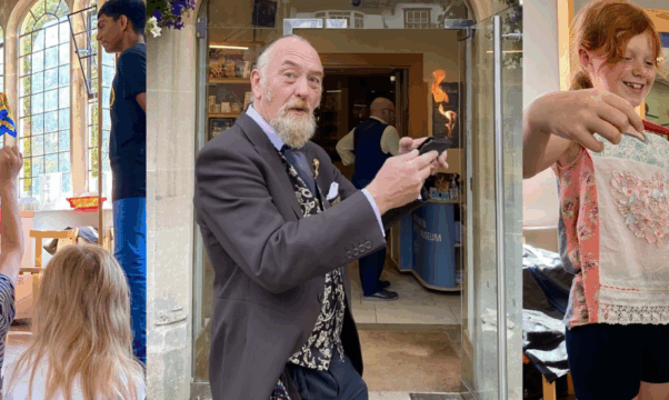 Tony Charles performing a magic trick in front of City Museum