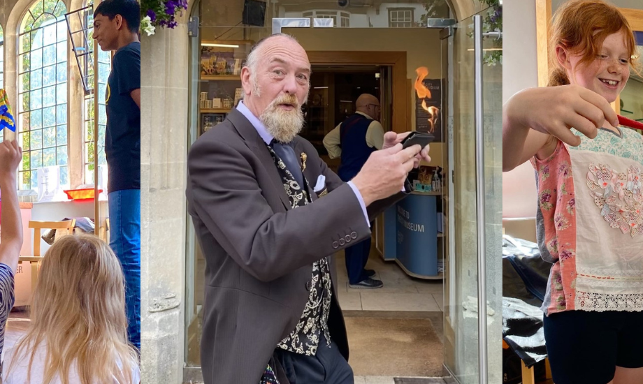 Tony Charles performing a magic trick in front of City Museum